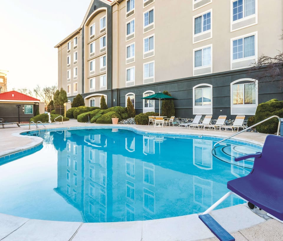 Dive into sunny relaxation with sparkling poolside loungers and views.
