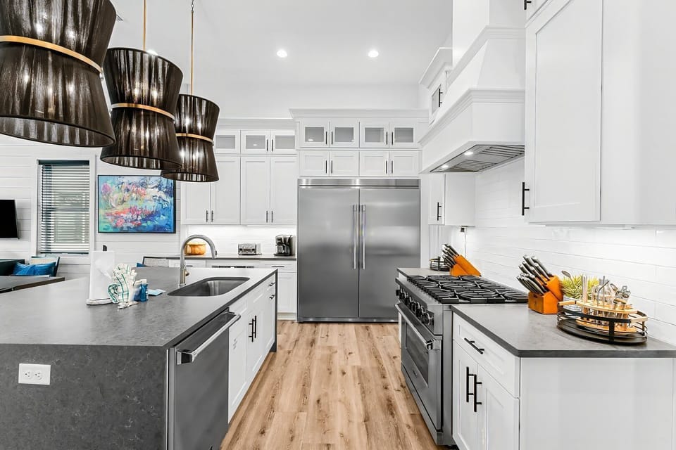 A fully equipped chef's kitchen featuring state-of-the-art appliances, a spacious oversized island, and a convenient walk-in pantry.