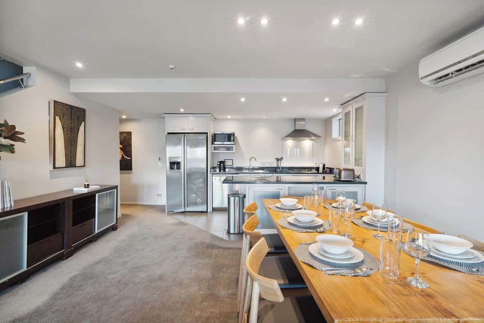 Open-concept layout connecting kitchen, dining, and living in one stylish space.