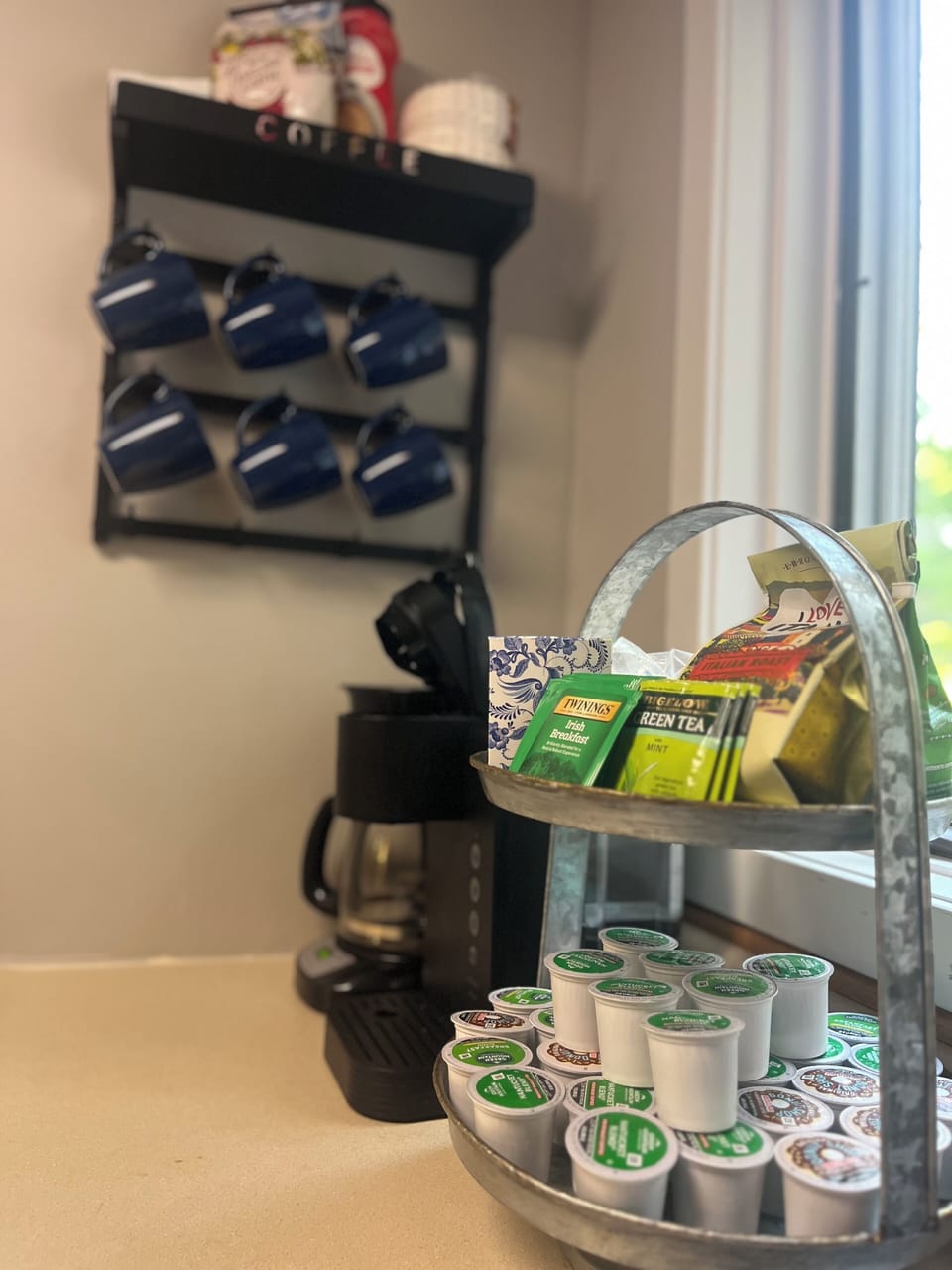 The coffee bar is stocked with a selection of complimentary coffee, tea, & cocoa