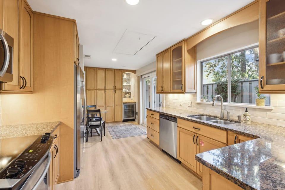 Fully stocked kitchen with stainless steel appliances .