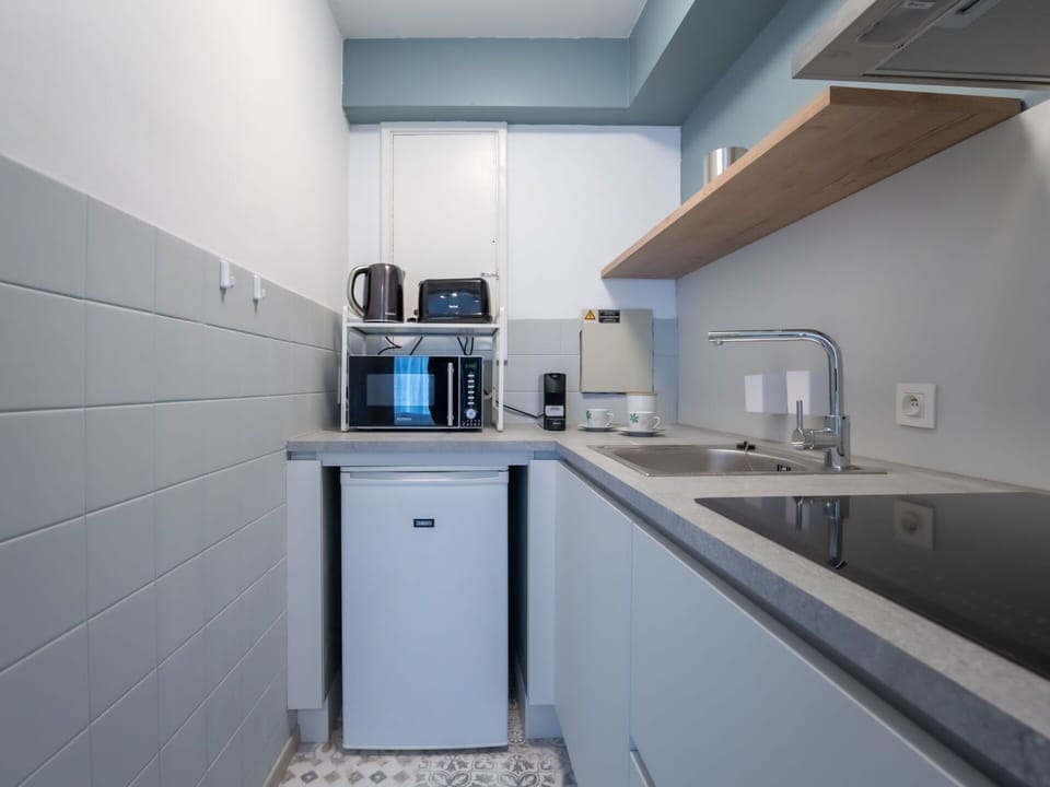 Kitchen, Countertop, Kitchen Appliance, Major Appliance, Flooring, Interior Design, Plumbing Fixture, Sink, Kitchen Sink, Cabinetry