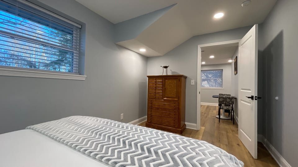 Rest easy in this cozy bedroom, featuring convenient drawers for extra storage and a clutter-free stay!