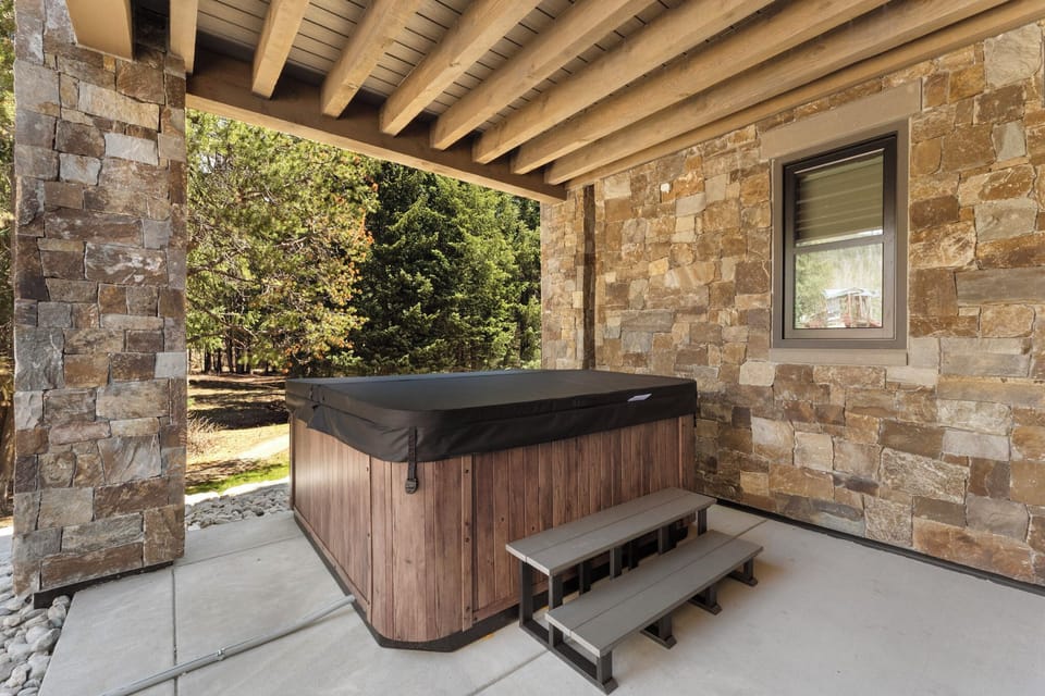 Soak your worries away in your private hot tub, sheltered beneath rustic beams with peaceful garden views stretching beyond.