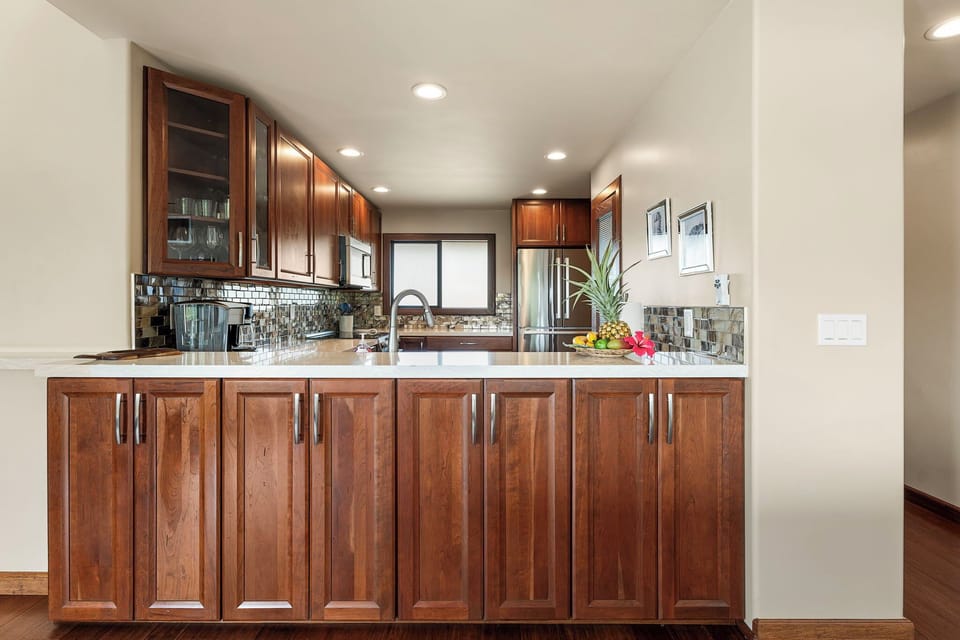 Fully-equipped kitchen with custom cabinetry and bar.