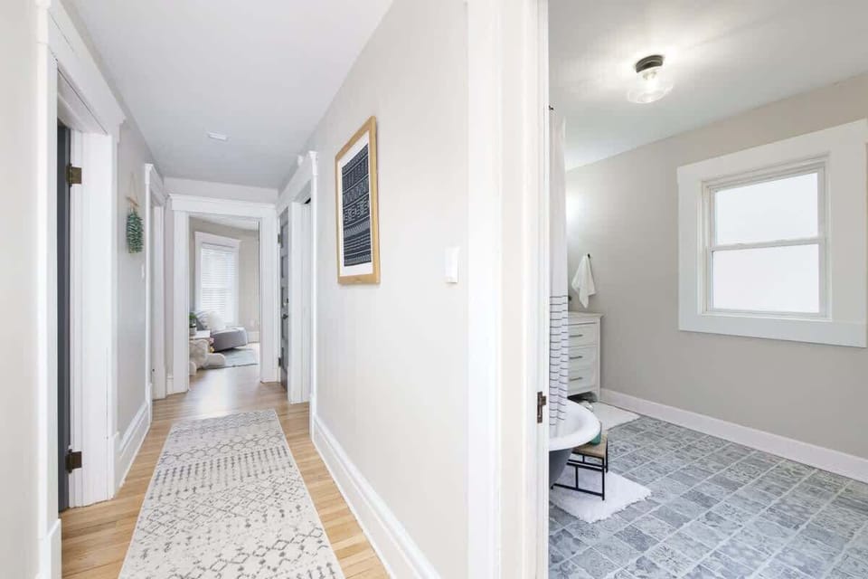 Bright hallway w/ clean lines, light flooring & an open feel throughout