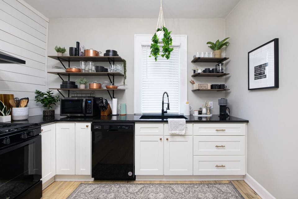 Black appliances, white cabinets, and a touch of rustic charm. This kitchen is a total win!