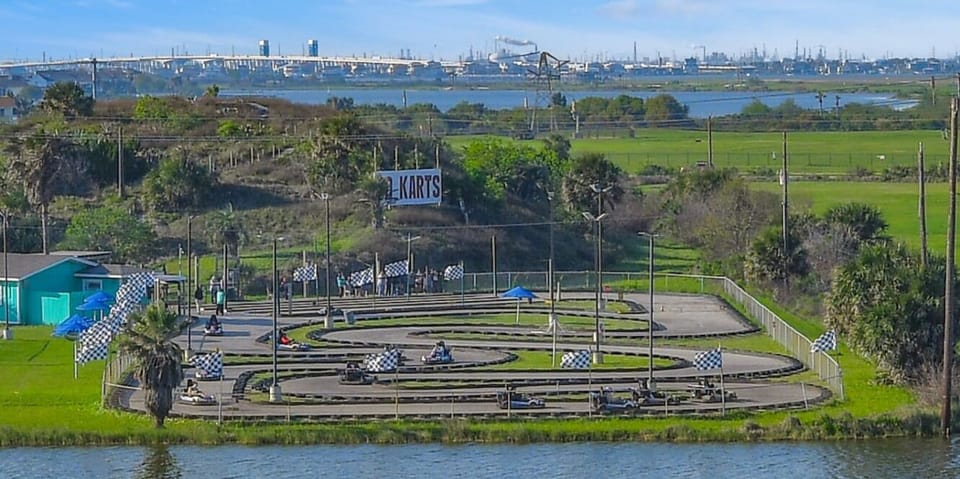 View of the lake and Galveston Go Karts And Fun Center from behind the condo | A short walk to fun and excitement