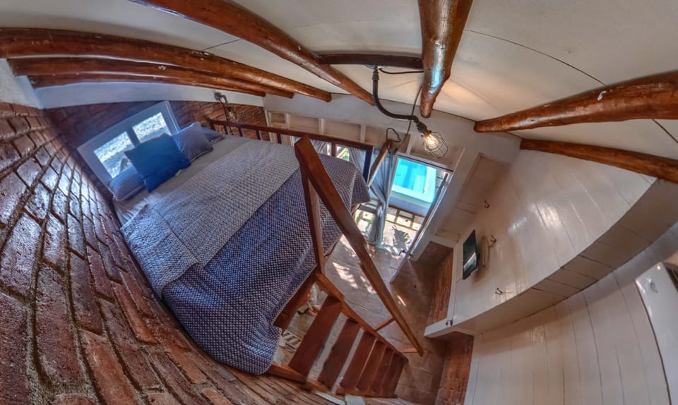 Double Loft bed with View over the beach.   Designer and comfortable Bedding and Pillows.