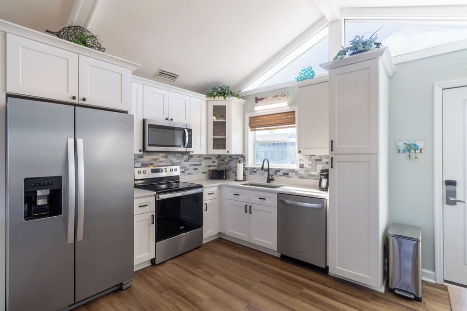 Kitchen - This kitchen is clean and contemporary with stainless appliances and tile backsplash.