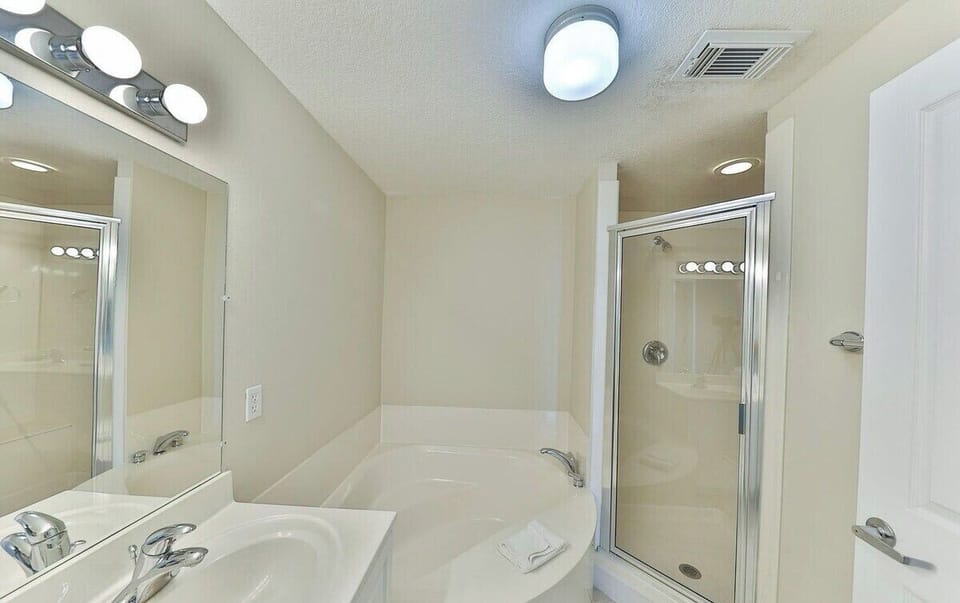 Master bathroom with dual vanity sink bathtub and walk in shower