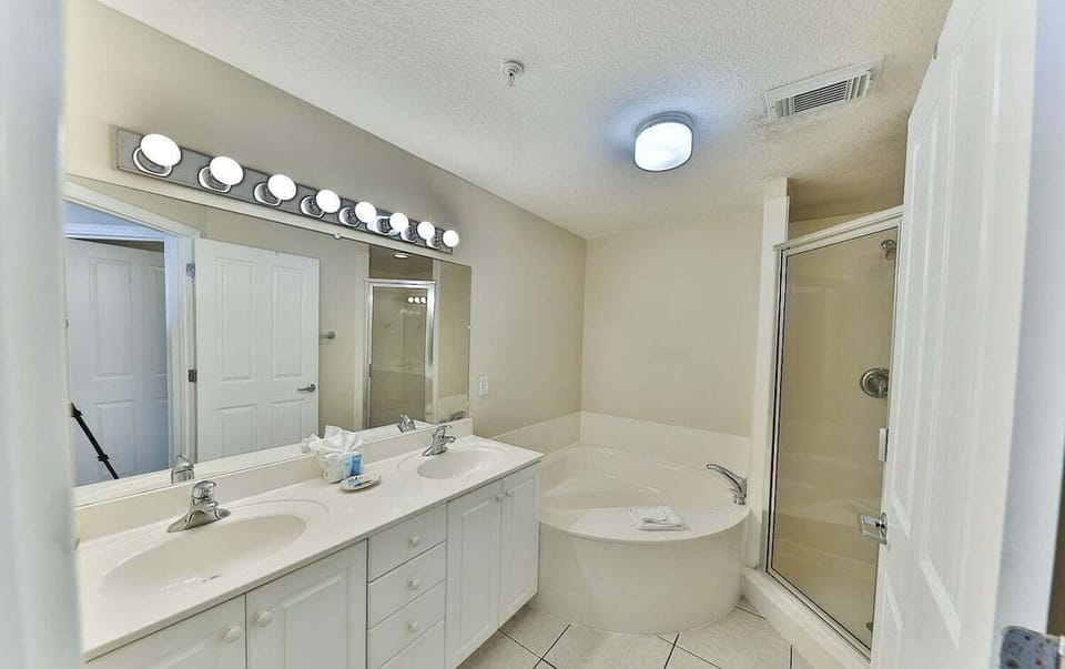 Master bathroom with dual vanity sink bathtub and walk in shower