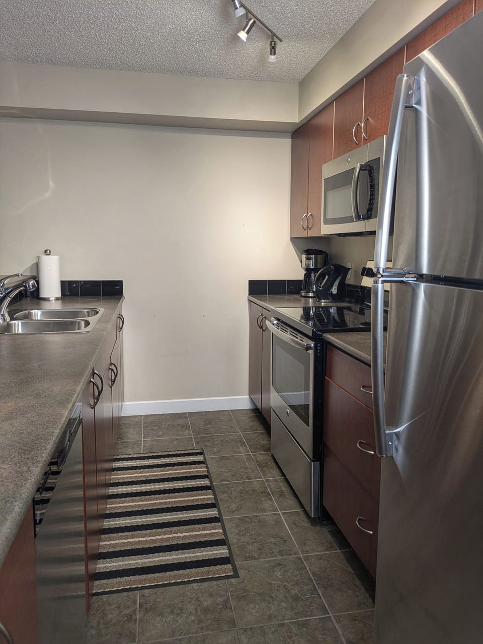 Fully equipped kitchen with stainless steel appliances.