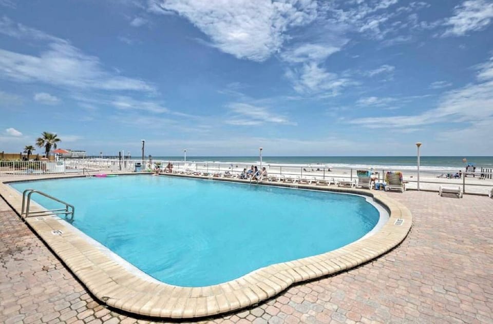 Relax in style by the sparkling pool with the beach just steps away.