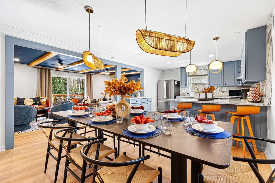 Bright and modern dining and living area with stylish decor, a spacious 8 seater dining table setup, and an open-concept kitchen perfect for gatherings.