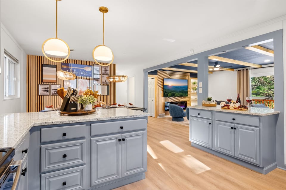 Granite countertops and soft gray cabinets offer a sleek, modern design.