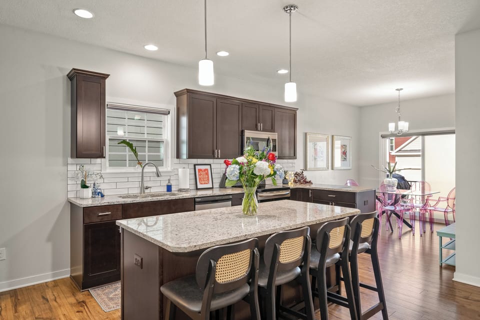 The kitchen island is perfect for a buffet, with lots of seating for all!