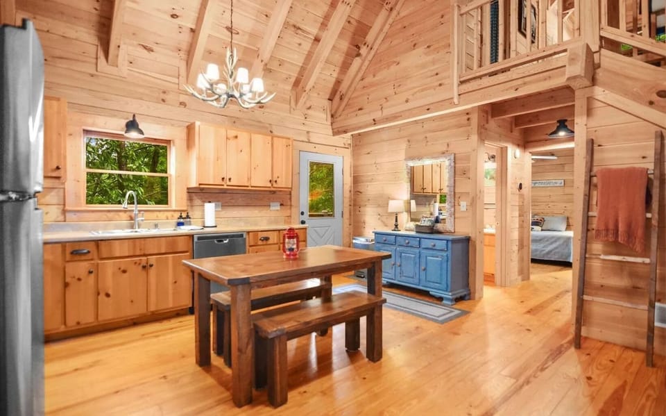 Kitchen with bench seats and additional chairs available next to fridge