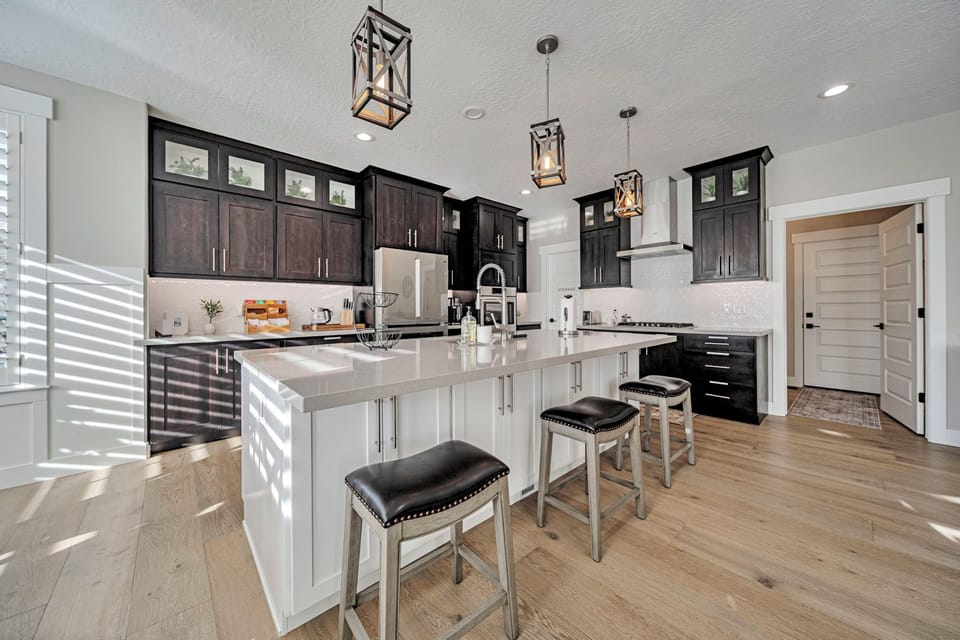 Bright gourmet kitchen with large island, seating, and modern finishes