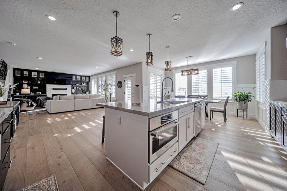 Bright open-concept kitchen and living space with stylish island seating