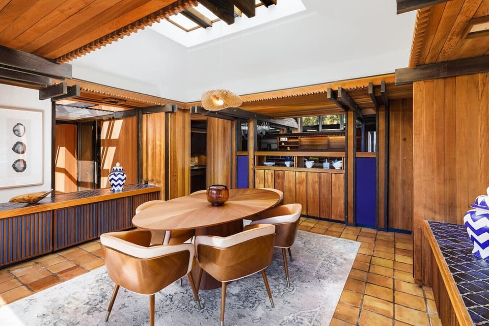 Elevate your dining experience in this stunning space with warm wood tones, modern lighting, and seamless indoor-outdoor flow—perfect for entertaining or intimate meals.