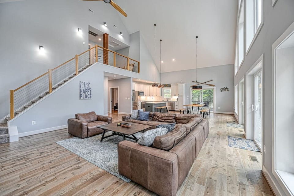 Bright open living area with loft and stunning water views—perfect for relaxing together.