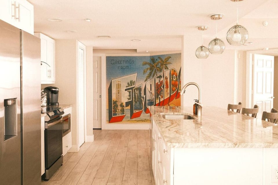 Spacious marble island, stainless appliances, and cheerful beachy vibes make cooking as fun as dining out.
