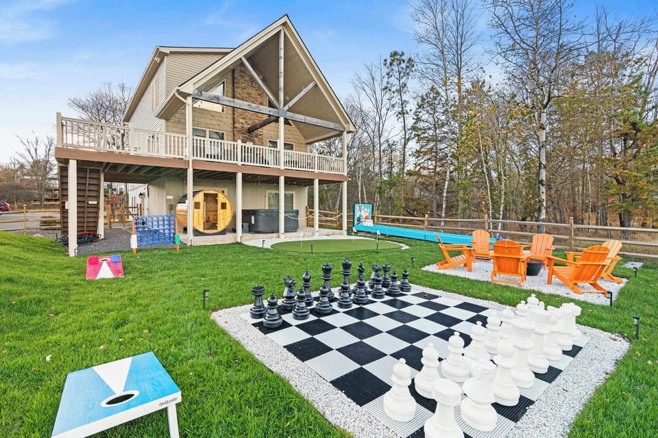 Lakefront backyard with giant chess board, Adirondack chairs and waterfront views