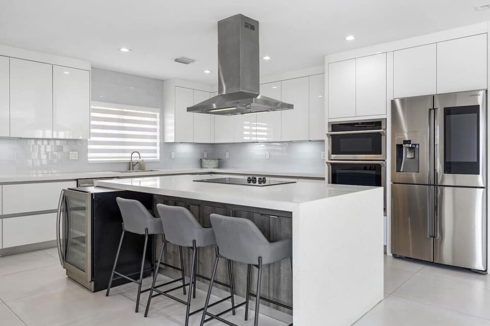 Modern culinary space with premium appliances and elegant breakfast bar arrangement
