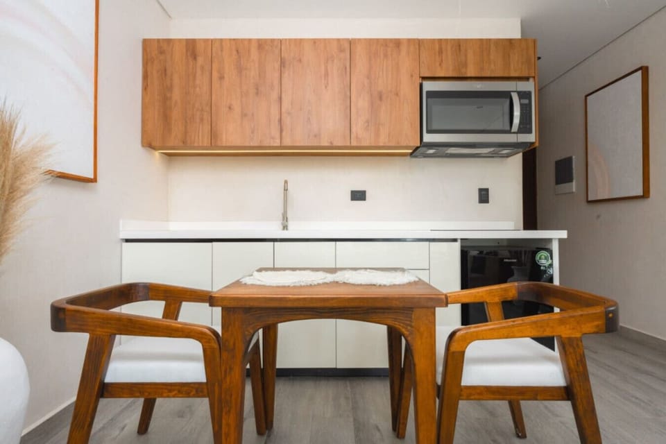 Kitchen with wood cabinets and small dining table.
