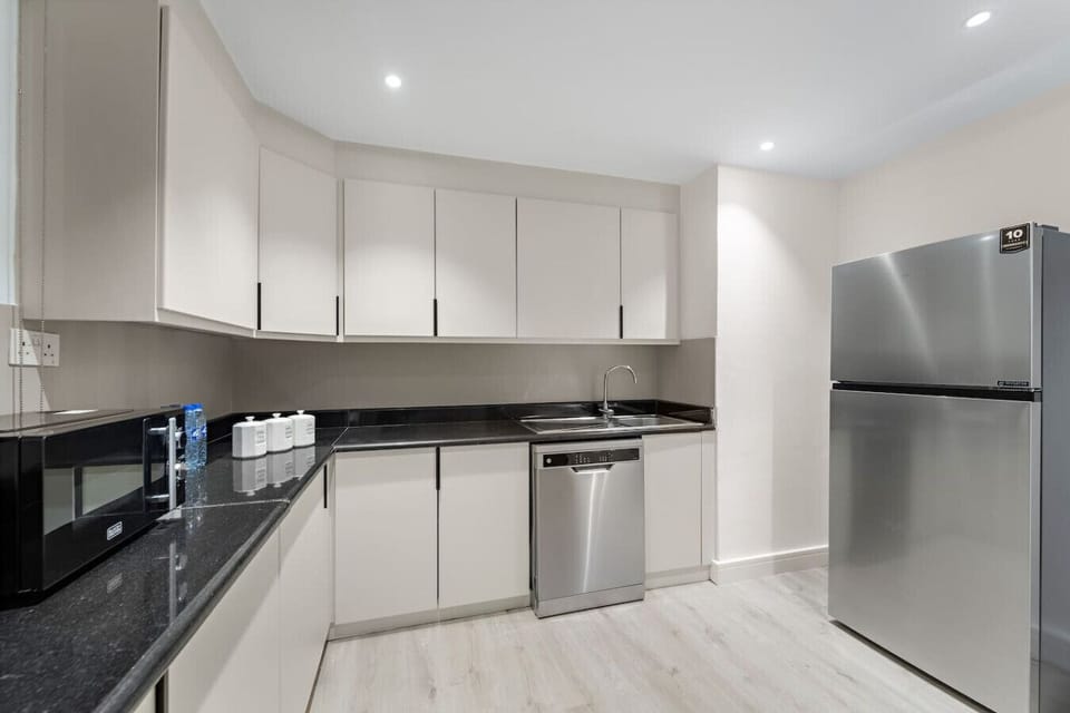 Kitchen: Sleek, modern appliances and spacious countertops for culinary adventures await!