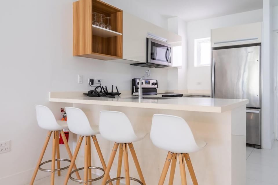 Spacious kitchen with a stylish island & bar seating, perfect for easy dining - Fully equipped with stainless steel appliances and sleek finishes for a clean and modern look - Well designed space that blends function and style effortlessly