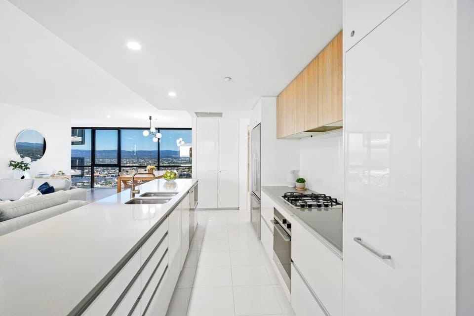 Large bright kitchen with modern stainless steel appliances.
