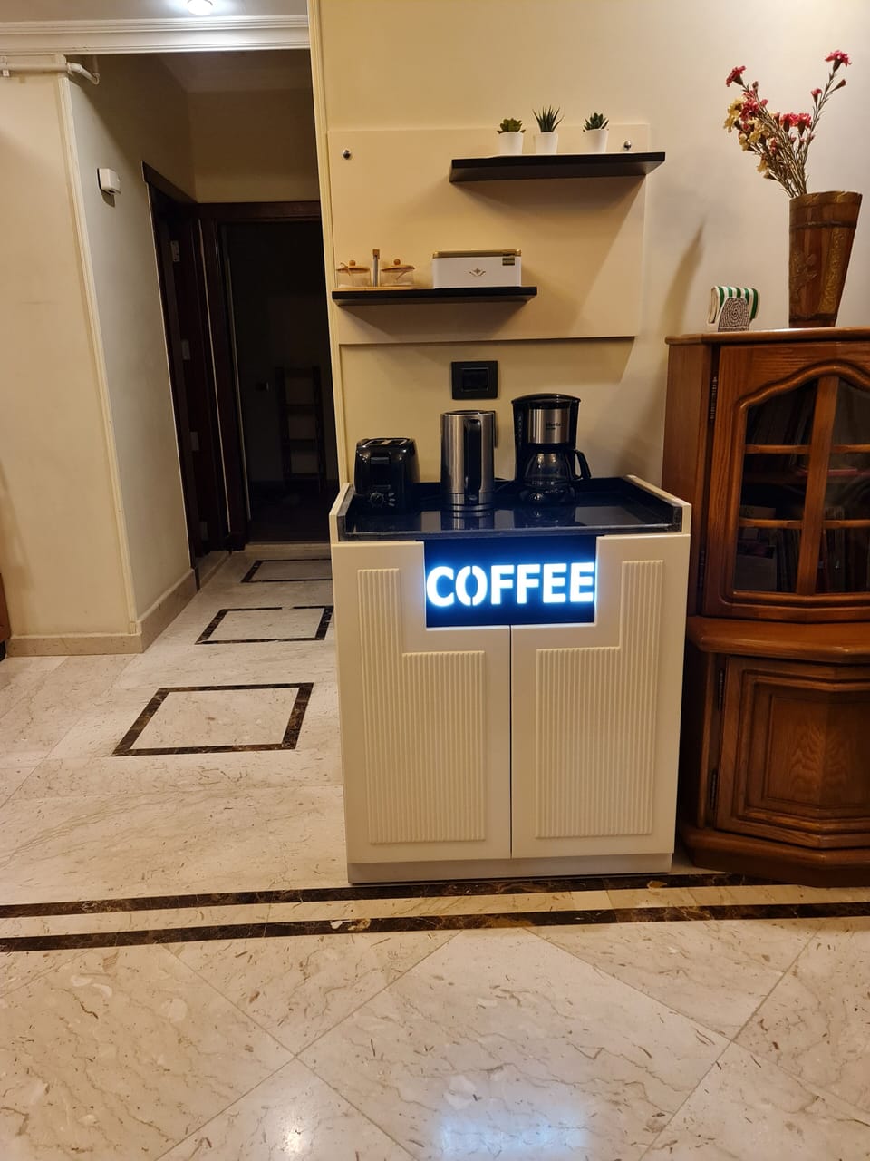 A coffee station with a coffee machine , a kettle, and a toaster.