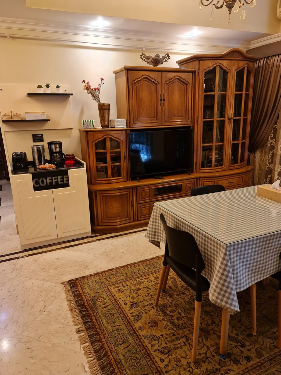 Dining area with a coffee station and a smart TV.
