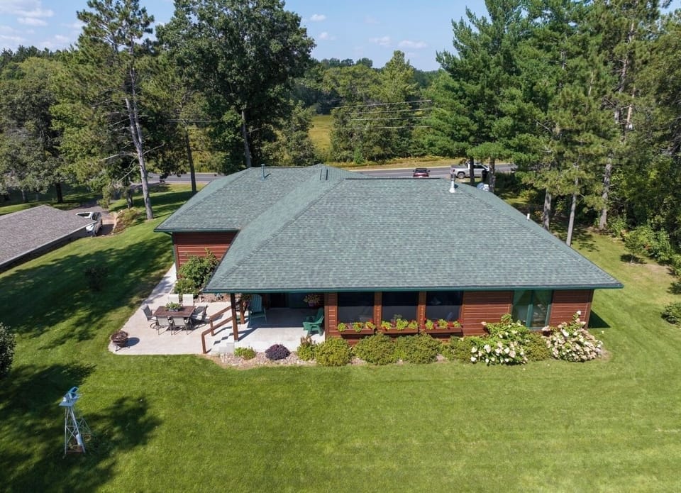 View from the back of 3 season screen porch, covered patio and patio dining