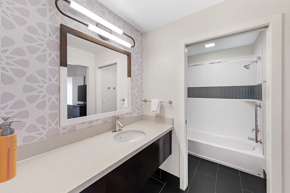 Soak and reset in a spotless bath with bright lighting.