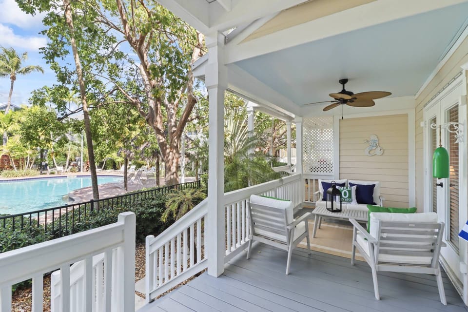 The shaded back deck offers a peaceful retreat perfect for sipping your morning coffee or unwinding with an evening cocktail overlooking the pool.