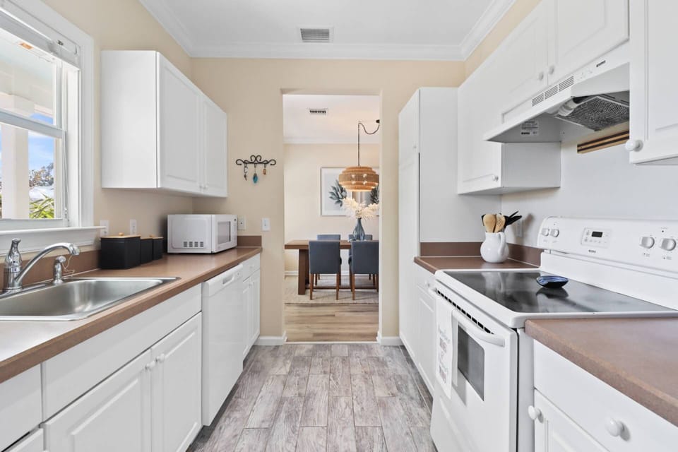 The kitchen seamlessly flows into the dining room, creating space for easy meal preparation and casual dining with family and friends.