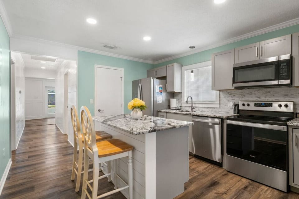Prepare delicious meals in the fully equipped modern kitchen with stainless steel appliances and a spacious island