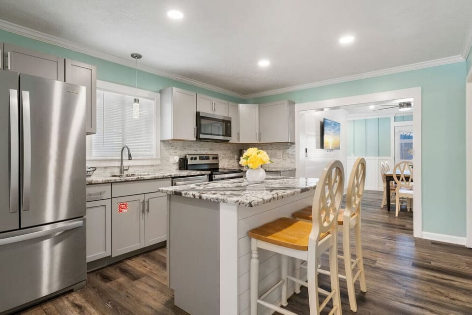 Prepare delicious meals in the fully equipped modern kitchen with stainless steel appliances and a spacious island