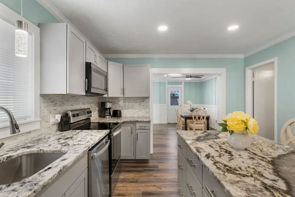 Prepare delicious meals in the fully equipped modern kitchen with stainless steel appliances and a spacious island