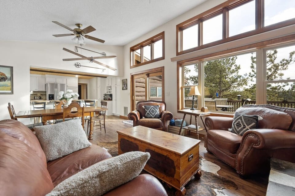 With high ceilings and expansive windows, the living and dining areas seamlessly connect to the deck, allowing natural light to flood the space and offering easy access to outdoor views and relaxation.