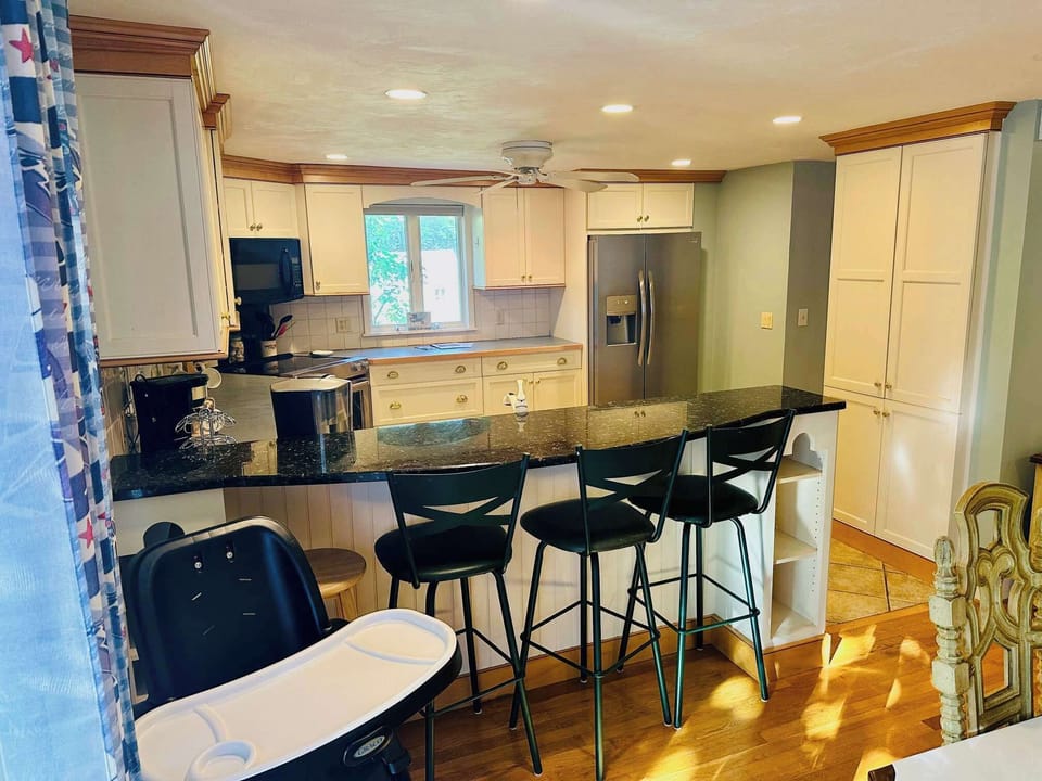 View from the Deck into Kitchen and Dining room. Provided High Chair.