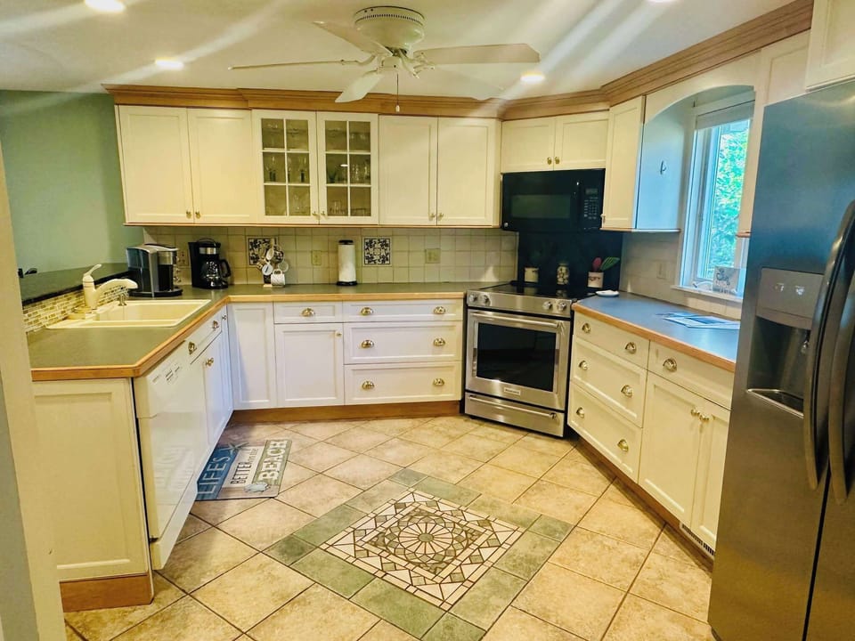  Large Kitchen with stainless steel appliances. Stocked with all dishes, cookware and utensils. Full pot and Keurig Coffee makers.
