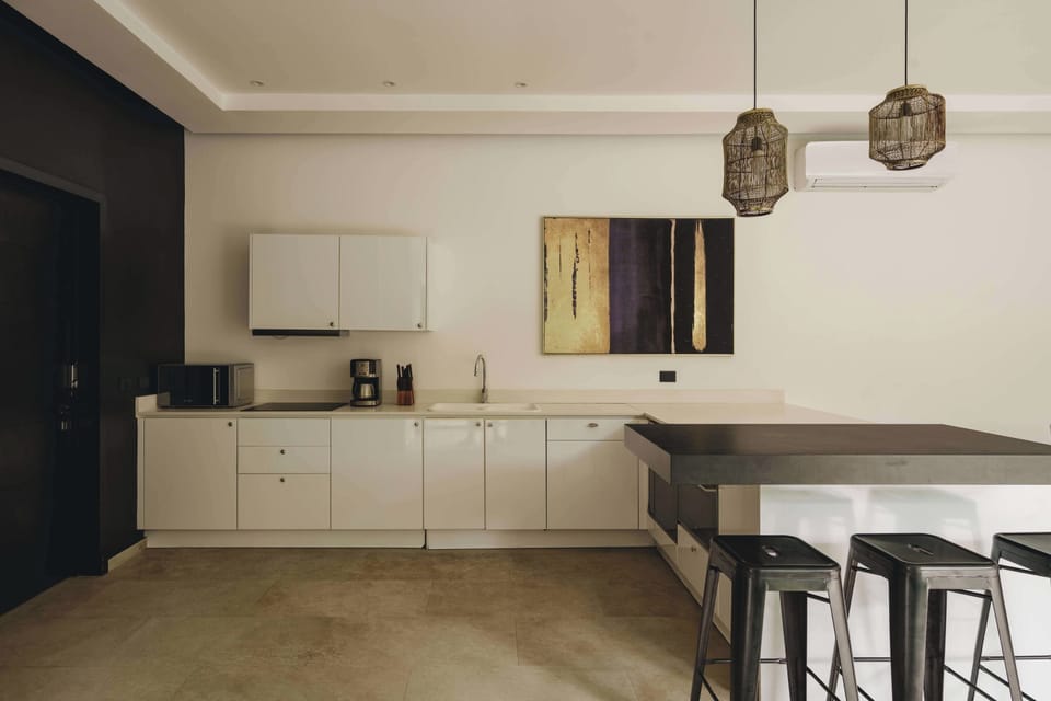 Modern fully equipped kitchen. It has a beautiful bar with seating for three people.