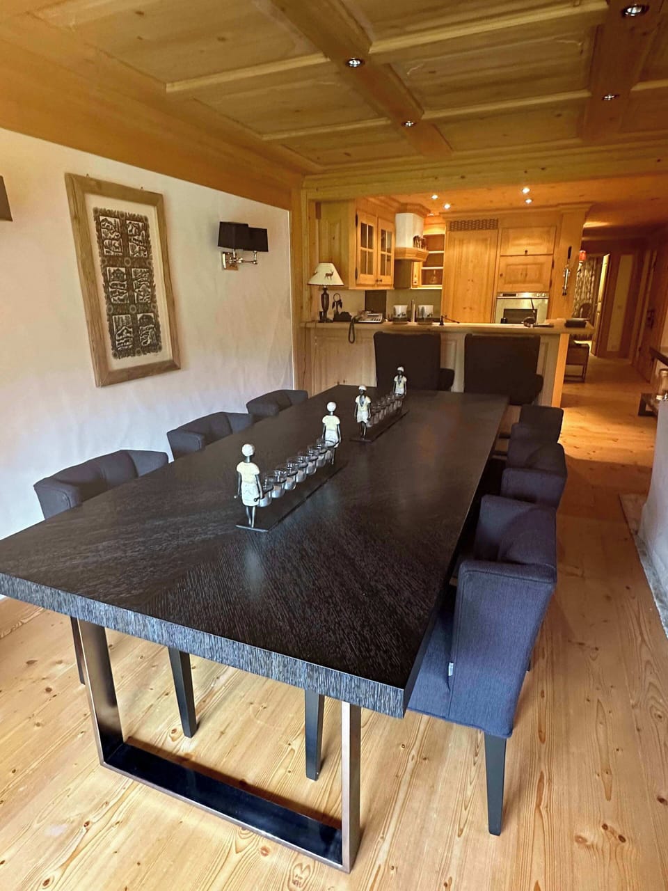 The living room features a dining table with an open kitchen located behind it.