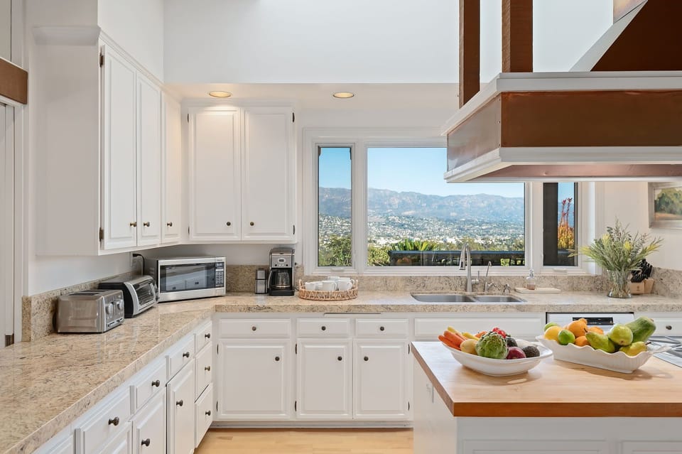 Fully equipped kitchen with city and mountain views