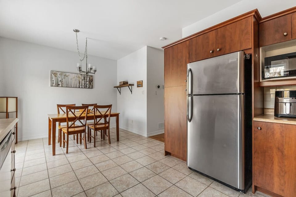 Kitchen pantry wall with built-in fridge, microwave, and extra counter space.