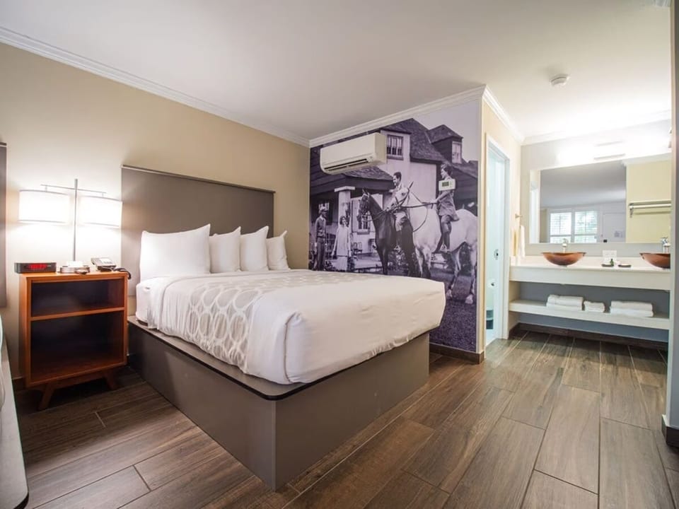 Unwind on plush king bedding beside convenient vanity setup.